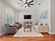 Comfortable living room features a ceiling fan and a large rug at 3535 Lake Sarah Dr, Orlando, FL 32804