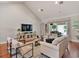 Bright living room with vaulted ceilings, hardwood floors, and sliding doors to the outdoor area at 3535 Lake Sarah Dr, Orlando, FL 32804