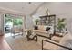 Comfortable living room with stylish furnishings, a large window, and access to the outdoor pool area at 3535 Lake Sarah Dr, Orlando, FL 32804