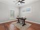 Home office featuring hardwood floors, a desk, and a window with blinds at 3535 Lake Sarah Dr, Orlando, FL 32804