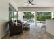 Covered patio with comfortable seating overlooks the pool and backyard, ideal for outdoor entertaining at 3535 Lake Sarah Dr, Orlando, FL 32804
