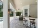 Inviting covered patio with bar seating, outdoor lighting, and a relaxing lounge area at 3535 Lake Sarah Dr, Orlando, FL 32804