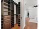 Walk-in closet featuring custom dark wood shelving and hardwood floors at 3535 Lake Sarah Dr, Orlando, FL 32804