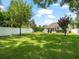 Large, fenced backyard with lush green lawn offers privacy and space for outdoor enjoyment at 3535 Lake Sarah Dr, Orlando, FL 32804