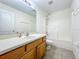 Bright bathroom features a large vanity with a white countertop and ample storage at 36730 Oconee Ave, Eustis, FL 32736