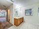 Bathroom featuring a vanity, a mirror, tile flooring, and an open doorway to the next room at 36730 Oconee Ave, Eustis, FL 32736