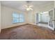 The spacious bedroom features a ceiling fan and a view of the outdoors at 36730 Oconee Ave, Eustis, FL 32736