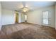 Bedroom featuring neutral walls, carpet, and access to the outside at 36730 Oconee Ave, Eustis, FL 32736
