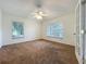 Bright bedroom with ceiling fan and dual windows, offering ample natural light at 36730 Oconee Ave, Eustis, FL 32736