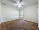 Cozy bedroom featuring a ceiling fan, neutral walls, and a window providing natural light at 36730 Oconee Ave, Eustis, FL 32736
