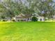 Charming home with a large front yard, mature trees, and meticulous landscaping at 36730 Oconee Ave, Eustis, FL 32736