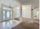 Inviting foyer with tile flooring and a view into the spacious, carpeted living area at 36730 Oconee Ave, Eustis, FL 32736