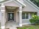 Charming front entrance with decorative door, manicured landscaping, and a welcoming porch at 36730 Oconee Ave, Eustis, FL 32736