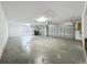 Spacious three-car garage with ample room for parking and storage, with visible wear on the floor at 36730 Oconee Ave, Eustis, FL 32736