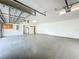 Bright three-car garage featuring white walls and ample space for vehicles and storage at 36730 Oconee Ave, Eustis, FL 32736