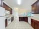 Spacious kitchen with modern appliances, dark wood cabinets, and tile flooring at 36730 Oconee Ave, Eustis, FL 32736