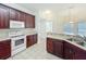 This kitchen features modern appliances, dark wood cabinets, and tile flooring at 36730 Oconee Ave, Eustis, FL 32736