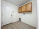 Functional laundry room with upper cabinets and hookups for a washer and dryer at 36730 Oconee Ave, Eustis, FL 32736