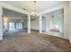 Open-concept living space with carpet, columns, and access to other rooms at 36730 Oconee Ave, Eustis, FL 32736