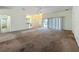 Spacious living room with a ceiling fan and sliding glass doors to the outside at 36730 Oconee Ave, Eustis, FL 32736
