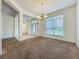 Open living room boasts natural light from a large window and stylish chandelier at 36730 Oconee Ave, Eustis, FL 32736