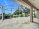 Covered outdoor patio space overlooking a manicured lawn, featuring a screen enclosure at 36730 Oconee Ave, Eustis, FL 32736