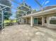 Spacious covered patio with sliding glass doors leading indoors, overlooking a well-kept lawn at 36730 Oconee Ave, Eustis, FL 32736