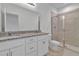 Bright bathroom featuring double vanity sinks, granite countertops, and a stand-up shower at 3756 Watercliff Cir, Grand Island, FL 32735