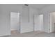 Spacious bedroom featuring gray carpet, an open entryway, and a closet at 3756 Watercliff Cir, Grand Island, FL 32735