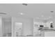 Spacious open-concept kitchen with stainless appliances and adjacent laundry room at 3756 Watercliff Cir, Grand Island, FL 32735