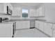 Modern kitchen featuring white cabinets, stainless steel appliances, and granite countertops at 3756 Watercliff Cir, Grand Island, FL 32735