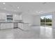 Open kitchen and living area with scenic views, stainless appliances and tile flooring at 3756 Watercliff Cir, Grand Island, FL 32735