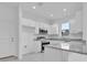 Modern kitchen featuring stainless steel appliances, gray countertops, and white cabinets at 3756 Watercliff Cir, Grand Island, FL 32735