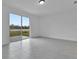 Spacious living room with sliding glass doors overlooking a scenic waterfront view at 3756 Watercliff Cir, Grand Island, FL 32735