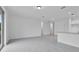 Open living area with tile floors connecting to the kitchen with a door to a covered lanai at 3756 Watercliff Cir, Grand Island, FL 32735