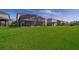 Expansive backyard featuring a screened-in pool area and lush green lawn extending to the property line at 3943 Crawley Down Loop, Sanford, FL 32773