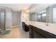 Elegant bathroom features dual vanities, granite countertops, and a glass shower at 3943 Crawley Down Loop, Sanford, FL 32773