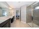 Spacious primary bathroom with dual sinks, a large mirror, and a walk-in shower at 3943 Crawley Down Loop, Sanford, FL 32773