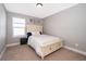Bedroom showcasing a bed with a decorative headboard, a nightstand, and a window for natural light at 3943 Crawley Down Loop, Sanford, FL 32773