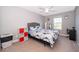 Comfortable bedroom featuring neutral walls, plush carpet, a ceiling fan, and a window with a view at 3943 Crawley Down Loop, Sanford, FL 32773