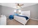 Bright primary bedroom with a large bed, ceiling fan, and natural light at 3943 Crawley Down Loop, Sanford, FL 32773