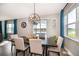 Dining room with views of the water, a modern chandelier, and seating for six at 3943 Crawley Down Loop, Sanford, FL 32773