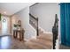 Inviting foyer featuring new laminate wood flooring, neutral paint colors, and stairway leading to upper level at 3943 Crawley Down Loop, Sanford, FL 32773