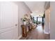 Bright foyer featuring wood flooring, neutral paint colors, and stairway adjacent to open-concept living area at 3943 Crawley Down Loop, Sanford, FL 32773