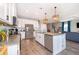 Modern kitchen with stainless steel appliances, granite countertops, and pendant lighting at 3943 Crawley Down Loop, Sanford, FL 32773