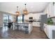 Modern kitchen with stainless steel appliances, granite countertops, and open to the dining area with a lake view at 3943 Crawley Down Loop, Sanford, FL 32773