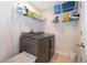 Functional laundry room with modern washer and dryer, shelving for storage, and neutral tones at 3943 Crawley Down Loop, Sanford, FL 32773