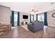 Comfortable living room features a ceiling fan, large windows, and stylish decor at 3943 Crawley Down Loop, Sanford, FL 32773