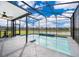 Sparkling screened-in pool area with serene water views, perfect for relaxation and outdoor enjoyment at 3943 Crawley Down Loop, Sanford, FL 32773