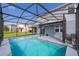 Backyard pool area featuring a screened enclosure, clear blue water, and well-maintained patio space at 3943 Crawley Down Loop, Sanford, FL 32773